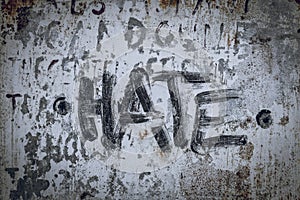 The word hate written on a industrial background