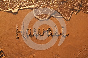 Word hawaii in the sand