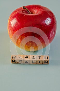 The word health written in cubes and an apple