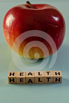 The word health written in cubes and an apple