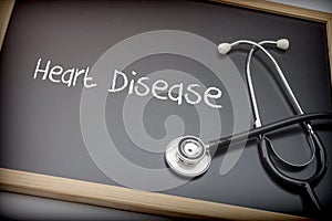 Word Heart Disease written in chalk on a blackboard black next t