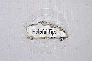 The word helpful tips appearing behind torn paper