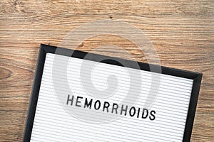 Word Hemorrhoids on letter board. Medical concept