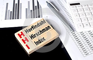 Word HHI - Herfindahl Hirschman Index made with wood building blocks with chart and calculator