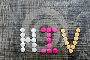 The word HIV(Human Immunodeficiency Virus) written whith pills o photo