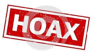 Word HOAX on red rubber stamp print