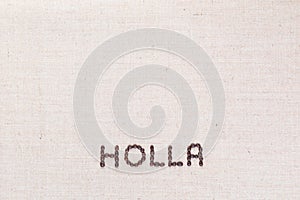 The word Holla written with coffee beans shot from above, aligned at the bottom