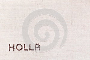 The word Holla written with coffee beans shot from above, aligned at the bottom left