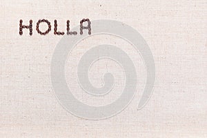 The word Holla written with coffee beans shot from above, aligned at the top left