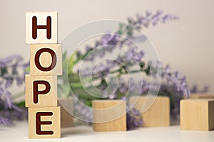 Word hope on a light background, wooden cubes