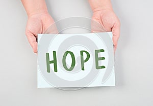 The word hope is standing on a paper, positive mindset