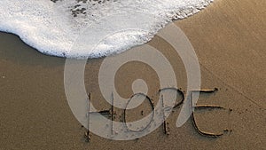 Word Hope written in The Sand