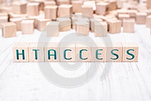 The Word htaccess Formed By Wooden Blocks On A White Table