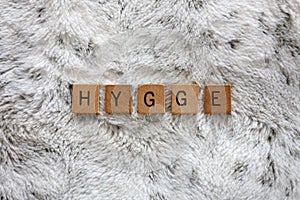 Word Hygge Spelled out with Wooden Letter Blocks on Soft Faux Fur Blanket