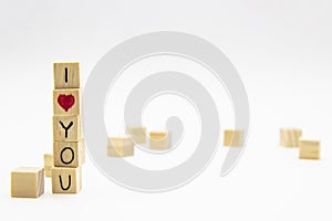 A word I love you written on the wood cubes. I love you lettering made of wooden cubes isolated on white