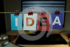 The word IDEA written on colorful note papers on board background. Idea concept
