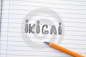 The word Ikigai on notebook sheet and pen