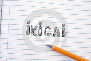 The word Ikigai on notebook sheet and pen photo