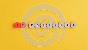 Word Impossible spelled on wooden cut circles