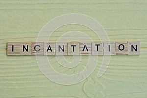the word incantation of gray small wooden letters