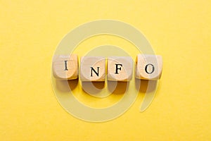 the word Info, text made with dice on yellow background