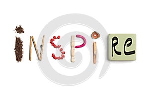 The word inspire created from office stationery.