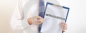 Word INTRODUCTION on paper in hands of businessman