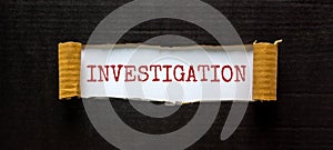 The word `investigation` appearing behind torn black paper. Business concept