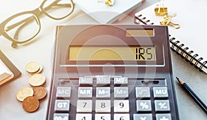 Word IRS - Internal Revenue Service, written on calculator on office table photo