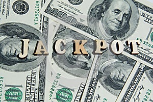 The word Jackpot on the 100 us dollar bills background. Macro view 100 dollar banknotes. Casino or Lotto Cash American Money