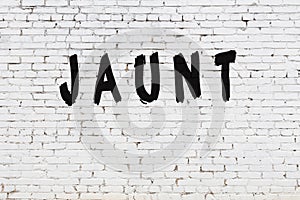 Word jaunt painted on white brick wall photo
