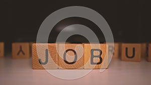 Word `job` of the wooden cubes. Job search concept