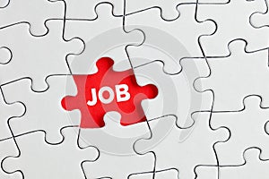The word job written on red missing puzzle piece. To search of to find a job