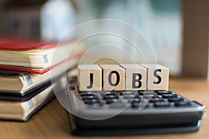 Word of JOBS spelled with colorful wooden alphabet blocks.Selective focus,shallow depth of field