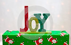 The word JOY on a Christmas present