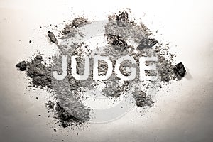 Word judge written in dirt, filth, ash, grime, dust as justice, photo