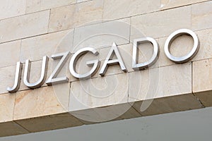 Word judged in Spanish. Court sign justice in metallic letters