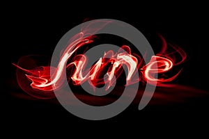 Word June on a black background smoke effect