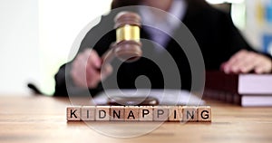 Word is kidnapping and judge is banging wooden gavel on table