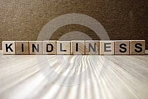Word kindliness from wooden blocks photo