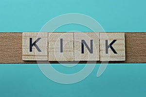 Word kink made from wooden gray letters