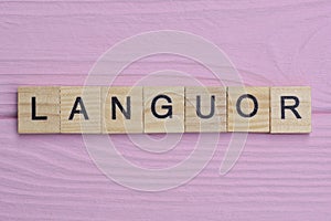 word languor from small gray wooden letters photo