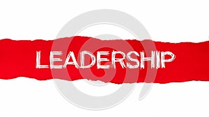 The word LEADERSHIP appearing behind red torn paper