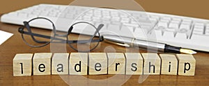 The word leadership on wood stamp