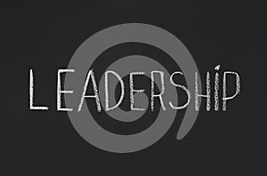 Word Leadership written with white chalk on blackboard