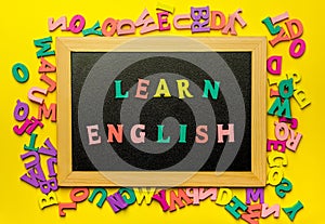 Word Learning english made with wooden letters over the wooden board