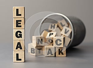 The word LEGAL made from wooden cubes. Shallow depth of field on the cubes