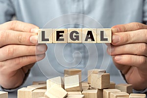 The word LEGAL made from wooden cubes. Shallow depth of field on the cubes