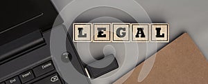 The word LEGAL made from wooden cubes. Top view