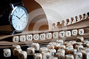 Word: linguistics next to letters, wristwatch and notepad. The concept of scientific research in linguistics and the history of